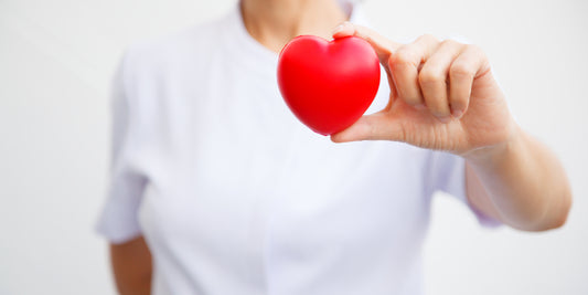 Photo of a woman holding a plastic heart - Allrj