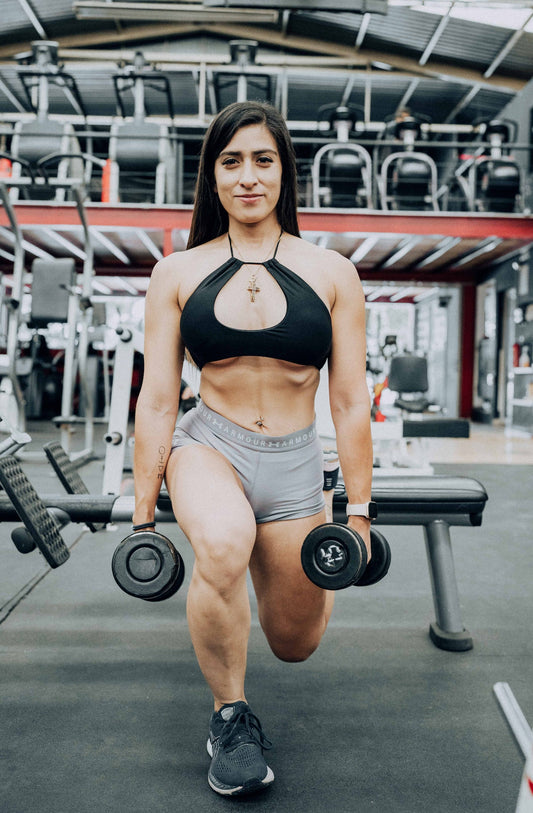 Fit woman doing bulgarian split squats